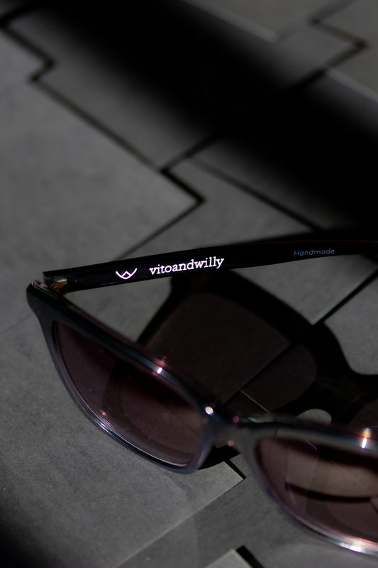 black framed sunglasses on gray textile