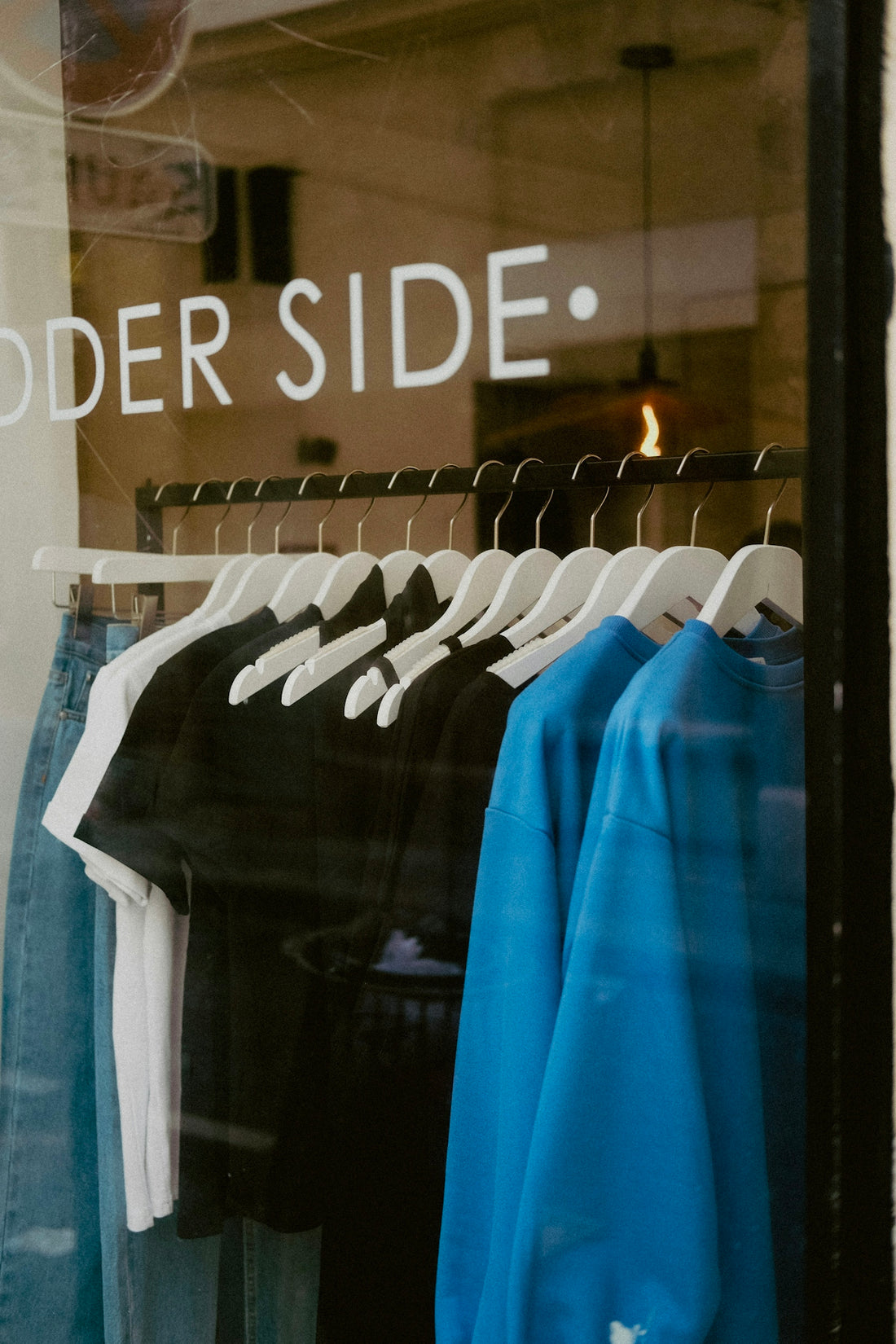 a store window with a group of shirts in it