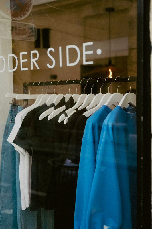 a store window with a group of shirts in it