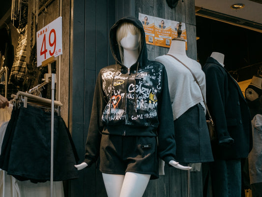 Mannequins in front of a clothing store display