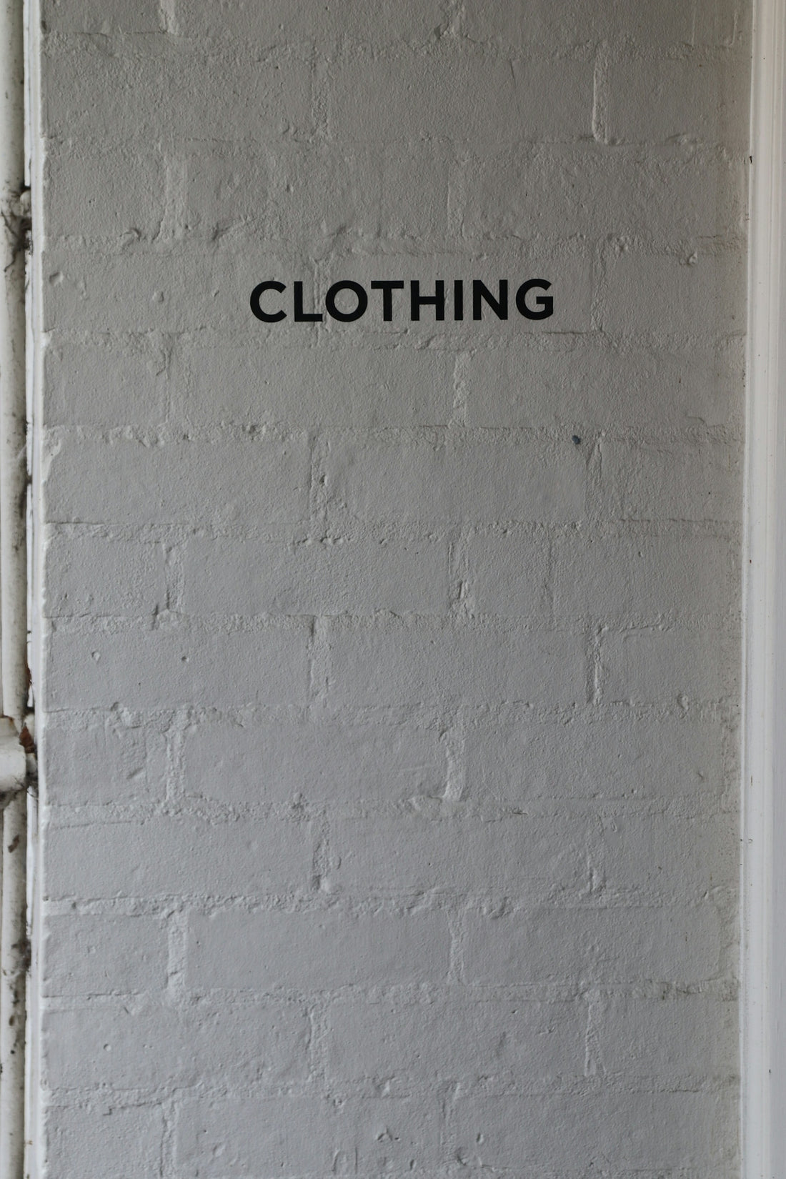 The word clothing is on a wall.