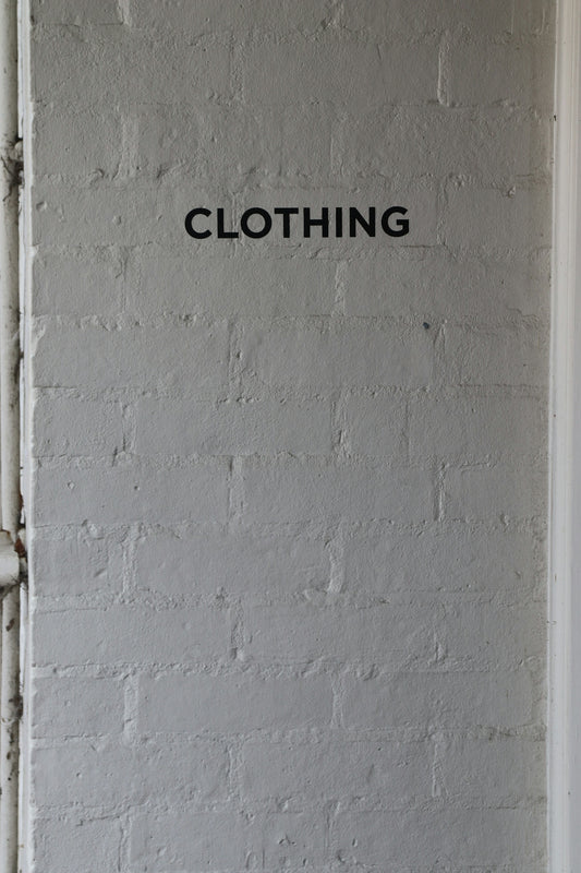 The word clothing is on a wall.