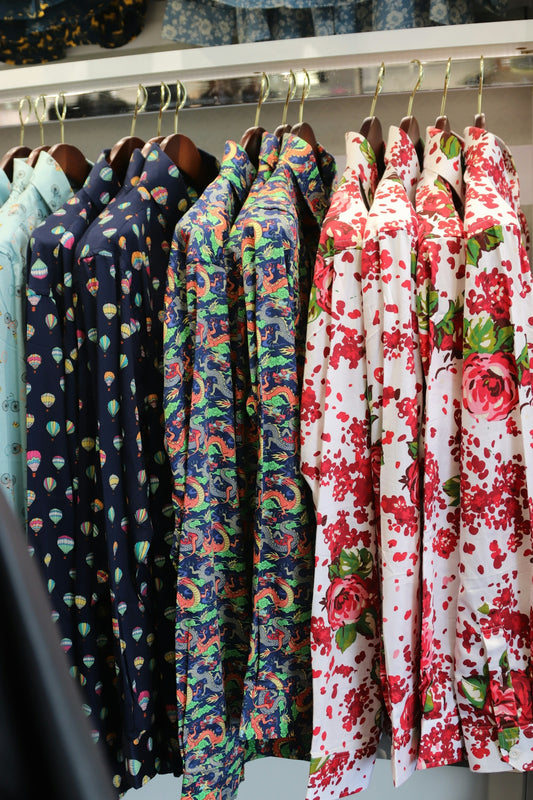 Shirts with unique patterns hang on display.