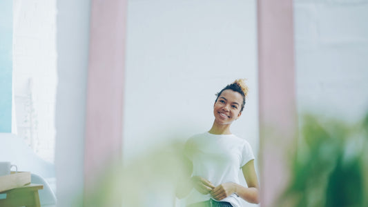 Young woman smiling in a mirror