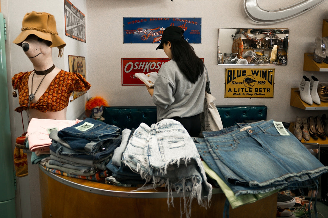 Woman browsing clothes in a vintage store.