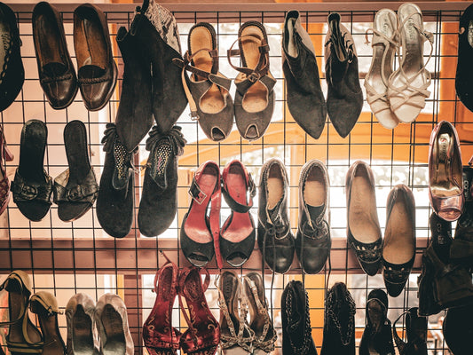 Assortment of vintage shoes displayed on a rack.