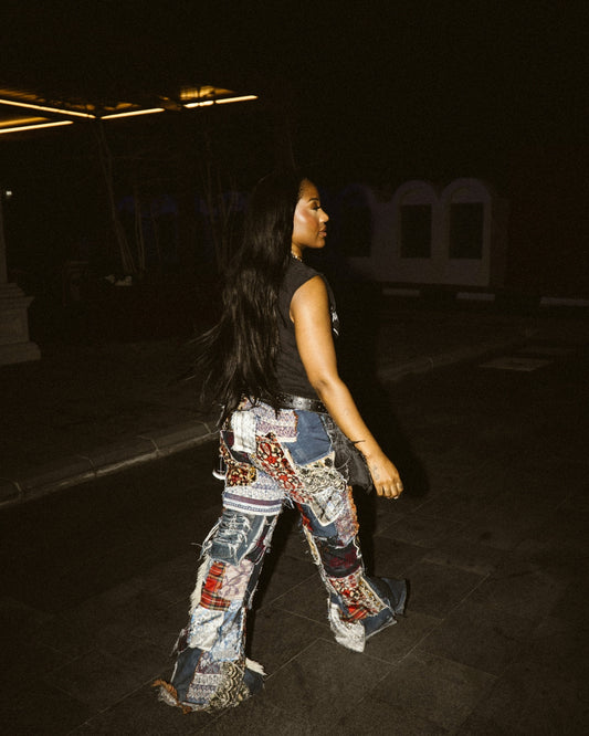 Woman walking at night in patchwork jeans