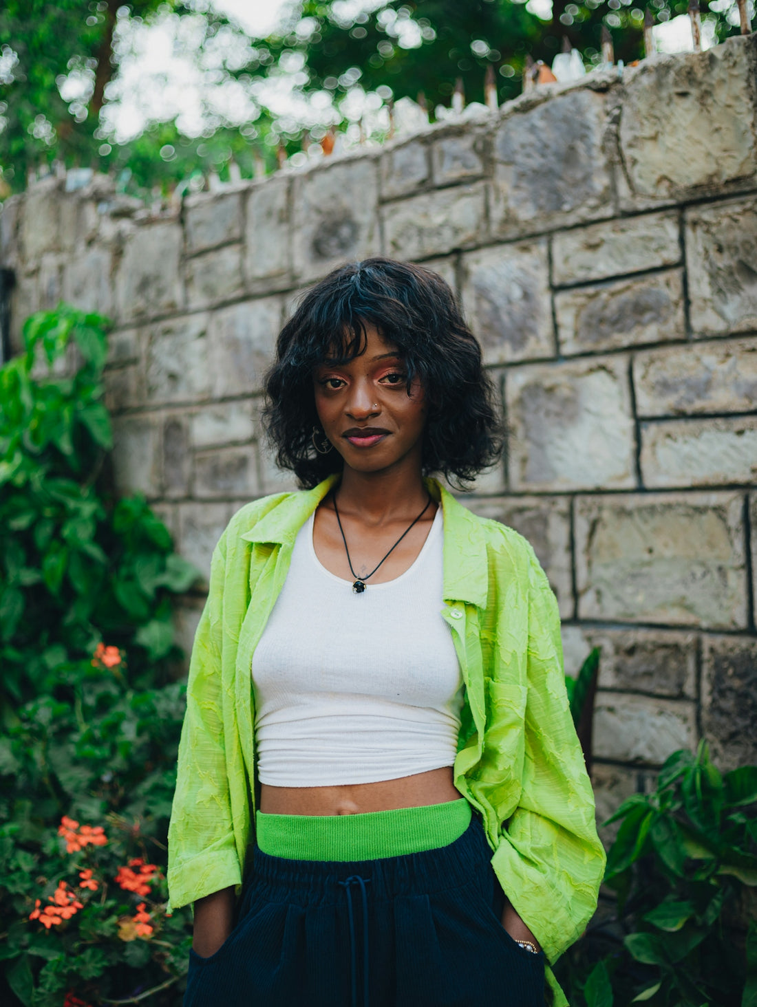 Young woman with dark curly hair and green shirt