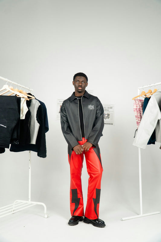 Young black man in stylish outfit with lightning pants.